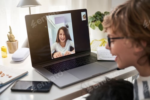 Preview: Cheerful boy video chatting with classmate