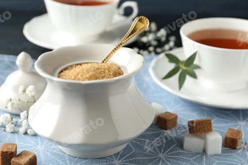 Preview: Ceramic bowl with brown sugar and cups of tea on table