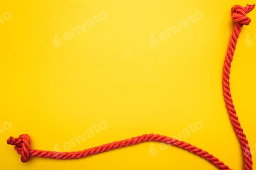 Preview: red jute ropes with knots isolated on orange