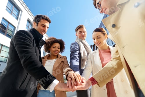 Preview: group of happy people holding hands in city
