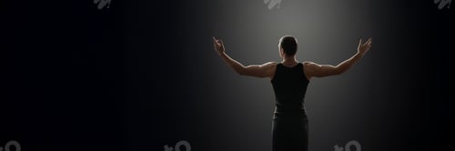 Preview: Man with Open Arms in Dark Wide Banner with Copy Space