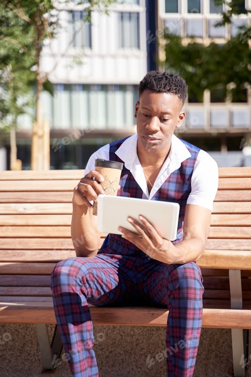 Preview: african american young man with tablet computer and take away coffee