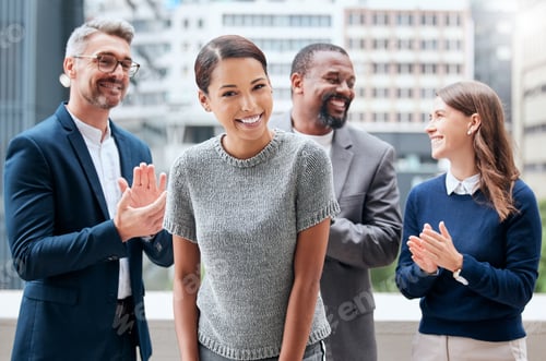 Preview: Too busy deciding who to let pay me. Portrait of a young businesswoman being applauded by her team.
