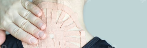 Preview: Close-up of kinesiology tape applied to caucasian adult males neck for pain