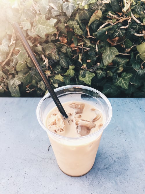Preview: Iced Latte with Straw on Textured Table