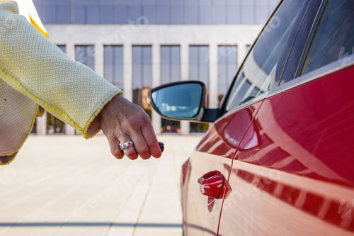 Preview: Close-up of old hispanic hand closing red car. Businesswoman is arriving at work