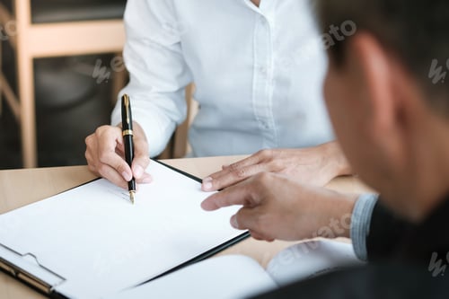 Preview: Business Colleagues Signing an Important Contract Together