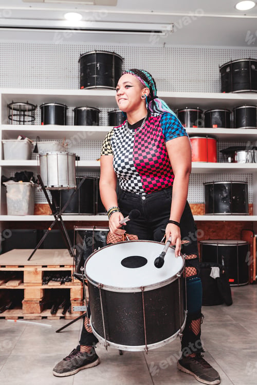 Preview: A girl playing a drum with maces surrounded by percussion instruments