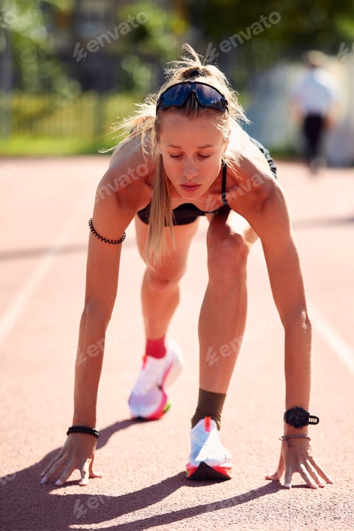 Preview: Woman getting ready to start on Stadium - summer outdoors training.