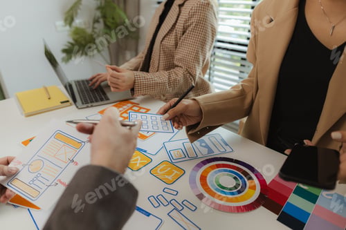 Preview: Digital product designers exchange ideas in their offices about how to design a website that meets t