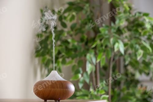 Preview: Aroma oil diffuser lamp on table against blurred background