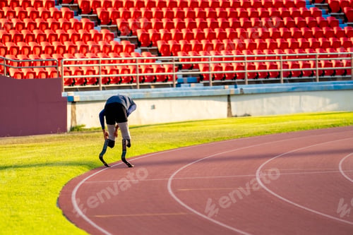 Preview: Asian para-athletes with prosthetic blades sprint on a running track at stadium.