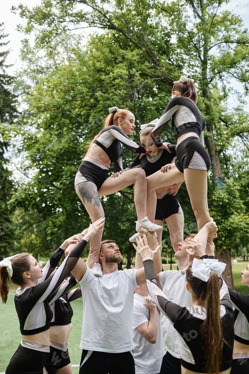 Preview: Cheerleader team training together outdoors