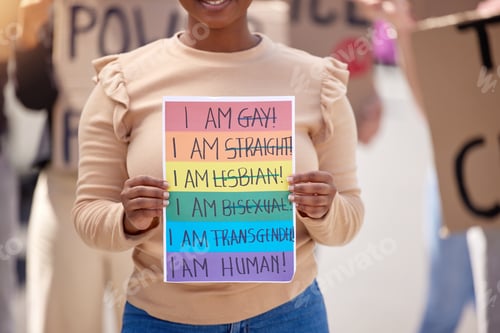 Preview: Love is a human condition. Shot of a woman holding up a sign at an lgbtq rally.