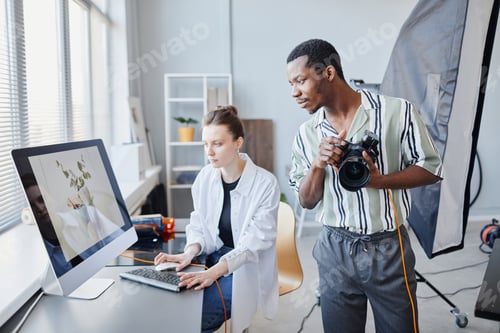 Preview: Two Photographers Editing Pictures In Studio