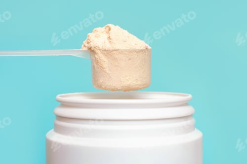Preview: Protein powder in scoop and plastic jar on blue background.