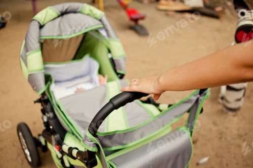Preview: Baby in Stroller with Hand on Handle
