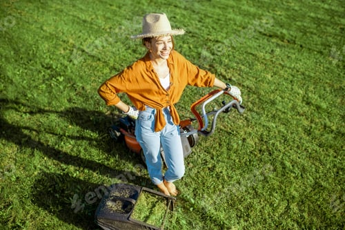 Preview: Woman with lawn mower on the backyard