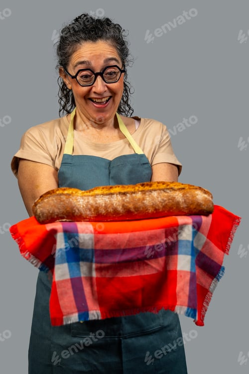 Preview: Baker woman showing freshly baked bread with enthusiasm