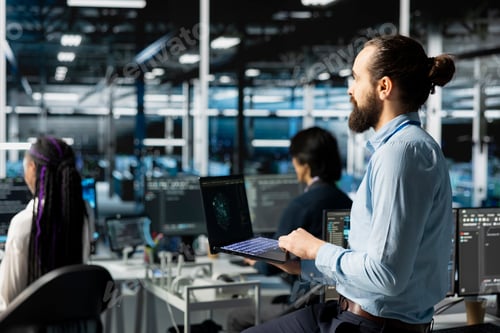 Preview: Teamworking engineers in data center installing server systems helped by AI