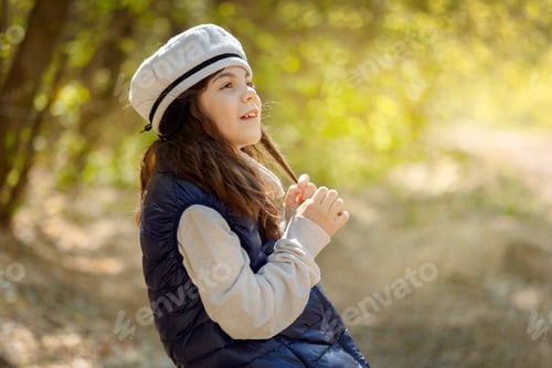 Preview: Little pretty girl on walk in sunny spring park. Fairy forest.