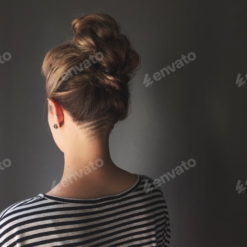 Preview: Back view of undercut and updo of hair.