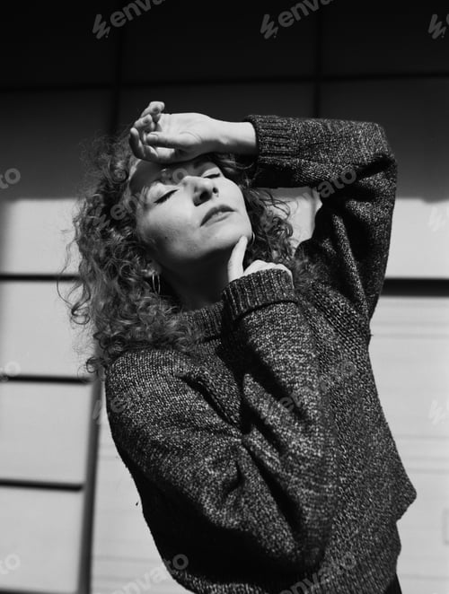 Preview: Portrait of young woman with closed eyes under the sunlight.