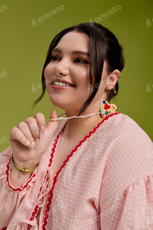 Preview: Stylish plus size woman showcases vibrant jewelry against a fresh, colorful backdrop