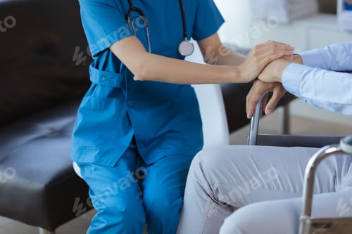 Preview: Doctor touches the arm to encourage the patient in the hospital examination room.