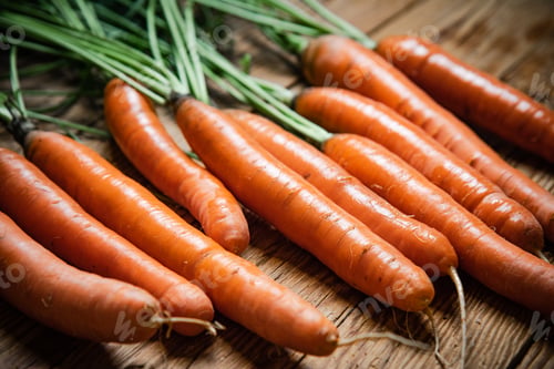 Preview: Fresh carrots on wooden table.