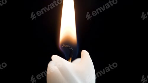 Preview: Close up detail of white wax lit candle flame and wick on isolated black background. andle lights