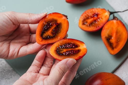 Preview: Freshly Cut Tamarillos Displaying Seeds and Vivid Color