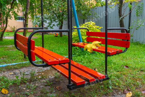Preview: Empty wet swing in the garden