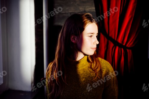 Preview: Beautiful young woman looking away indoors
