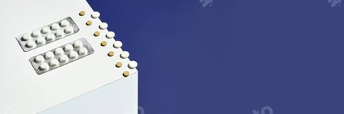 Preview: White and brown pills on white surface against blue background