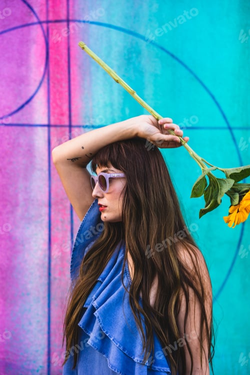 Preview: Woman holding flower with colorful background