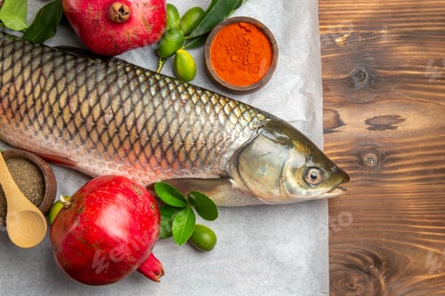 Preview: top view fresh fish with pomegranates on wooden table food seafood dish ocean