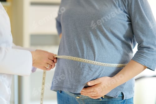 Preview: Gynecologist doctor measures with centimeter tape of a pregnant woman.