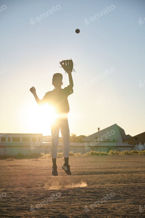 Preview: Boy jumping catching baseball glove at sunset