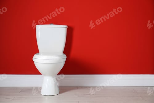 Preview: Toilet bowl near color wall in restroom. Space for text