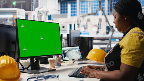Preview: Photovoltaics facility worker reviews data on green screen computer
