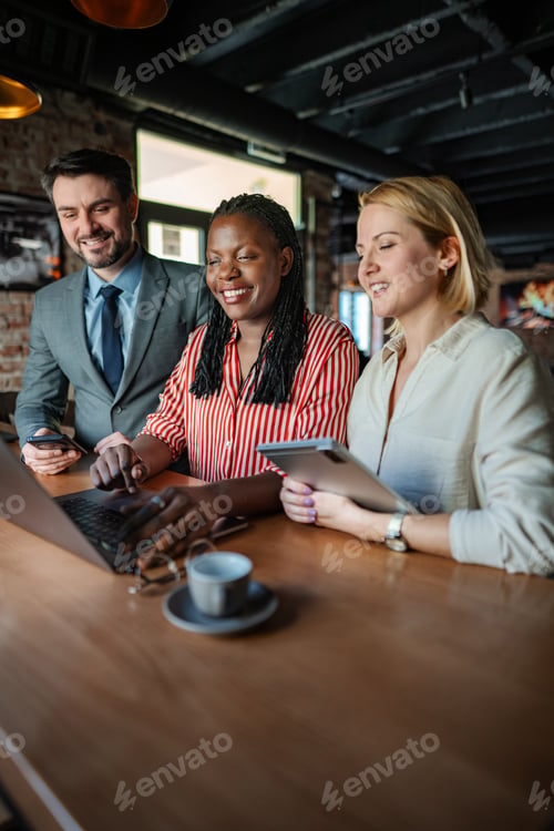 Preview: Diverse business people collaborating in modern coworking space