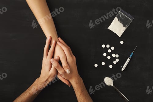 Preview: Drug addict hands on dark table