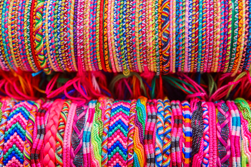 Preview: Colorful wristbands. Fabric textured background. Hand made. Horizontal