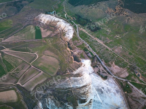 Preview: Aerial view of green fields landscape with a narrow road and several trails in Denizli city, Turkey