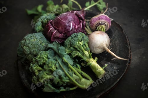 Preview: Closeup of cabbage and broccoli in a black plate, dark background
