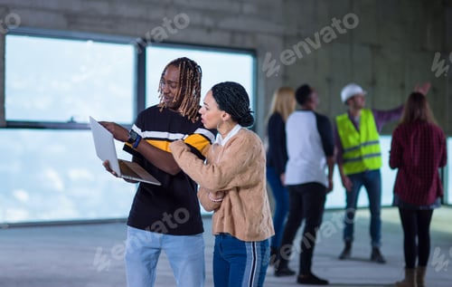 Preview: multiethnic business couple on construction site