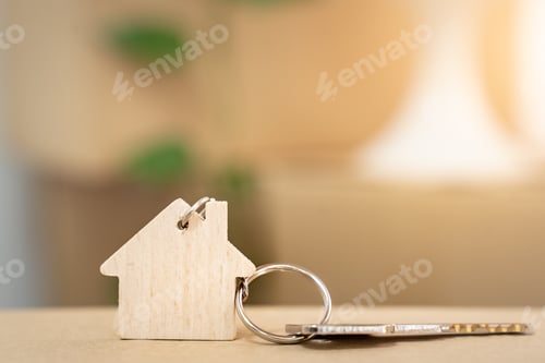 Preview: House keys on keyring in the shape of a wooden house with copy-space for text