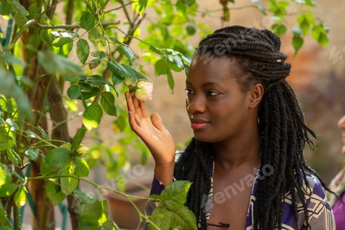 Preview: African-American woman with curly hair spending time in street