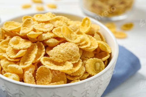 Preview: Tasty corn flakes on white table, closeup